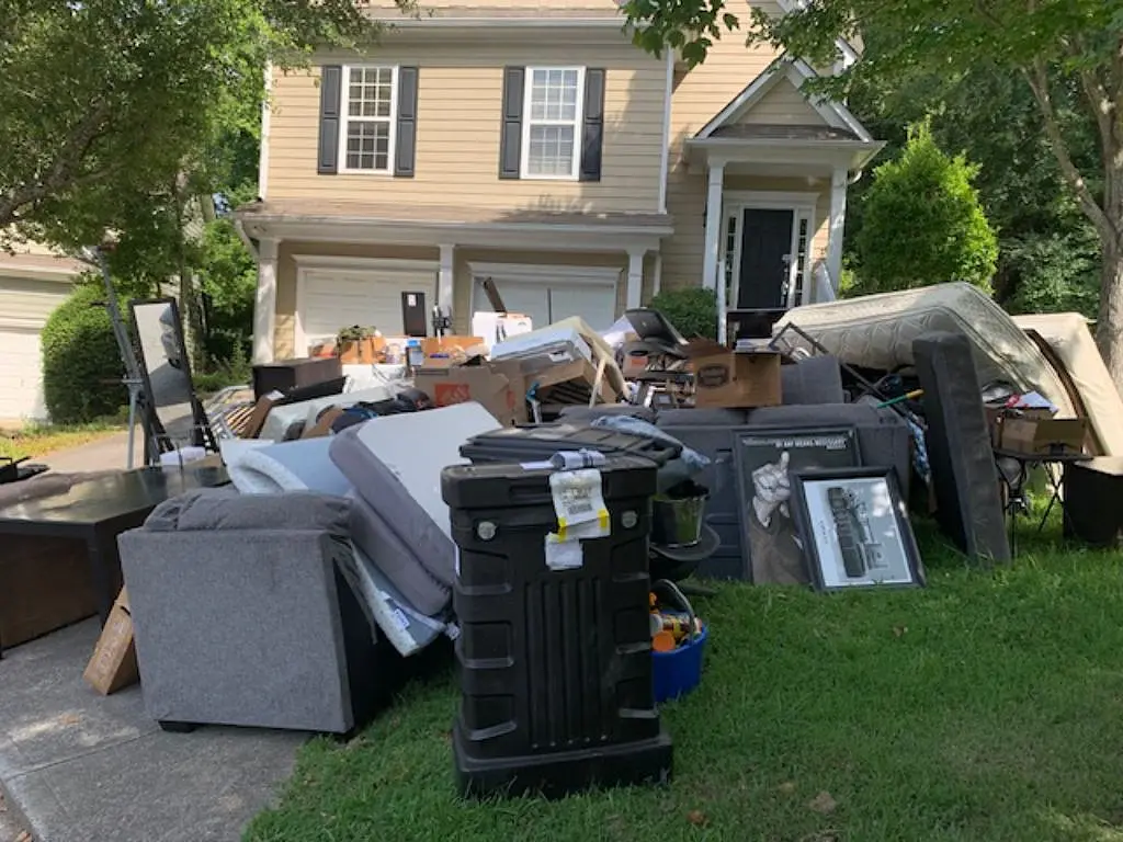 Furniture and household items gathered outside an Aurora home for an eviction cleanout